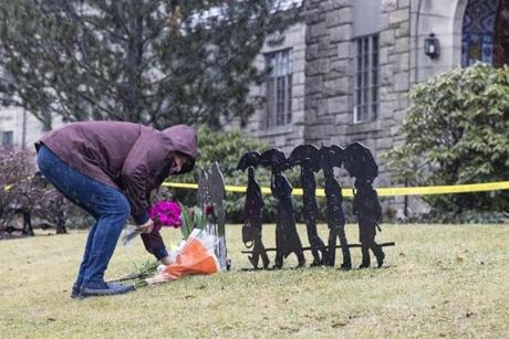 Winchester, MA - 2/25/2018 - Resident Cathy Frasso lays flowers at a makeshift memorial in front the the Winchester Public Library where a woman was fatally stabbed in Winchester, MA, Feb. 25, 2018. (Keith Bedford/Globe Staff)

