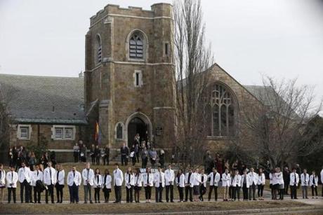 Students from the New England College of Osteopathic Medicine lined the sidewalk outside the Winchester Unitarian Society Thursday.

