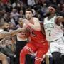 Boston Celtics' Marcus Morris, left, gets his hand on the ball as Chicago Bulls' Zach LaVine (8) drives to the basket as Jaylen Brown (7) also defends during the first half of an NBA basketball game Monday, March 5, 2018, in Chicago. The Bulls won 108-100. (AP Photo/Charles Rex Arbogast)