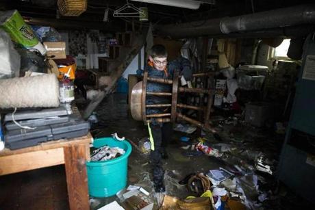 Quincy, MA - 3/5/2018 -Walter Bardon removes flood damage items caused by a massive storm from the basement of his family's home in Quincy, MA, Mar. 5, 2018. (Keith Bedford/Globe Staff)

