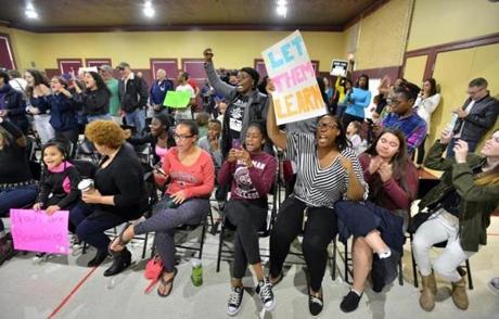 Demonstrators chant during a meeting of the Mystic Valley Regional Charter School Board in support of the young Black women who've been disciplined for their hair styles. The Board of Trustees then went into executive session. Josh Reynolds for The Boston Globe (Metro, ) 5/21/17
