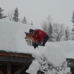 Al Santopietro shoveled snow off the porch roof of a ski rental building at Prospect Mountain ski area. 