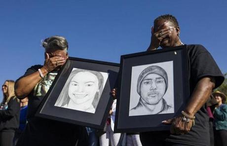 WALKOUT SLIDER Pat Gibson, left, and Valerie Davis cry while holding pictures of two of the victims killed in the Parkland shooting during the one-month anniversary walkouts to protest gun violence, outside Marjory Stoneman Douglas High School on Wednesday, March, 14, 2018. (Matias J. Ocner/Miami Herald via AP)
