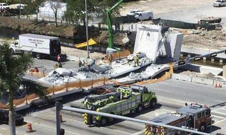 Emergency personnel respond to a collapsed pedestrian bridge at Florida International University. 
