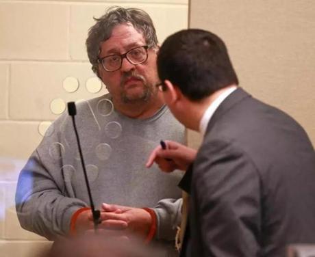 Michael Hand spoke with his attorney Craig Tavares (right) as he is arraigned in connection with the 1986 murder of 15-year-old Tracy Gilpin at Brockton District Court on Wednesday.
