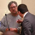 Michael Hand spoke with his attorney Craig Tavares (right) as he is arraigned in connection with the 1986 murder of 15-year-old Tracy Gilpin at Brockton District Court on Wednesday.