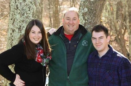 Scott Berry (center, with children Caitlyn and Christopher) was being a good neighbor when his life was changed forever. 
