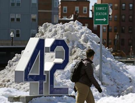 Jackie Robinson?s number 42 is displayed next to Yawkey Station. Sox owner John Henry (left) wants to change the name of Yawkey Way.
