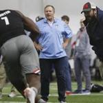 Georgia linebacker Lorenzo Carter (7) works with New England Patriots head coach Bill Belichick, center, and Detroit Lions head coach Matt Patricia, right, during Georgia Pro Day, Wednesday, March 21, 2018, in Athens. Pro Day is intended to showcase talent to NFL scouts for the upcoming draft. (Joshua L. Jones/Athens Banner-Herald via AP)