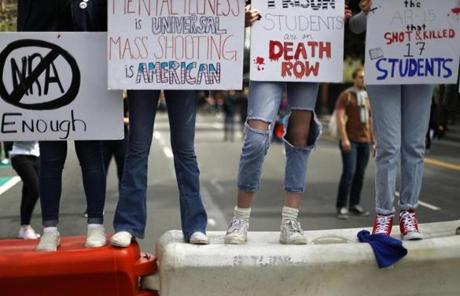 Young activists stood on a traffic barrier in Los Angeles.
