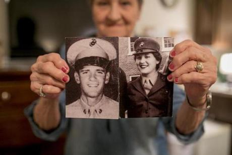 Mary Lou DiCicco held up military photos of herself and her husband, Robert, in the Marines.

