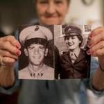 Mary Lou DiCicco held up military photos of herself and her husband, Robert, in the Marines.