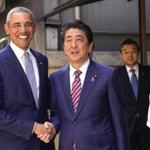Former U.S. President Barack Obama, left, and Japanese Prime Minister Shinzo Abe pose for photographers in front of Kyubey, a Japanese sushi restaurant, at Ginza shopping district In Tokyo Sunday, March 25, 2018. Obama said Sunday that negotiations with North Korea on its nuclear weapons program are difficult, partly because the country's isolation minimizes possible leverage, such as trade and travel sanctions against Pyongyang. At right is the restaurant's chef Yosuke Imada. (AP Photo/Shizuo Kambayashi, Pool)