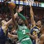 Boston Celtics guard Jaylen Brown (7) lays the ball up as Utah Jazz's Rudy Gobert, left, and Donovan Mitchell (45) defend in the second half of an NBA basketball game Wednesday, March 28, 2018, in Salt Lake City. (AP Photo/Rick Bowmer)