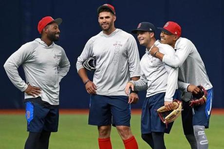 St. Petersburg, FL: 3/28/2018: Red Sox outfielders (left to right) Jackie Bradley, Jr. J.D. Martinez, Andrew Benintendi and Mookie Betts had some fun as they get ready for Opening Day. Martinez will be making his Red Sox debut in the game. The Boston Red Sox held a workout session today to get ready for the Opening Day of the 2018 baseball season at Tropicana Field. (Jim Davis/Globe Staff)
