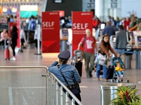 A State Police officer monitored the crowd at Logan Airport?s Terminal A.
