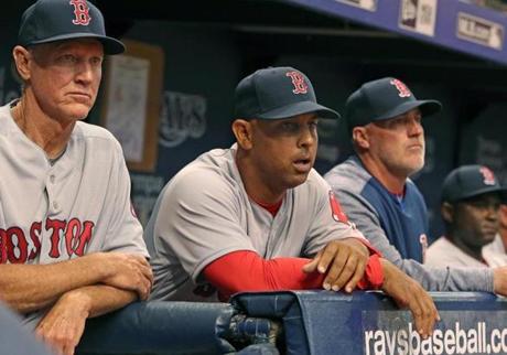 St. Petersburg, FL: 3/29/2018: The looks on the faces of Red Sox bench coach Ron Roenicke (left) manager Alex Cora (center) and pitching coach Dana LeVangie (right) tell the story as they watch the Boston bullpen implode in the bottom of the eighth inning. The Boston Red Sox visited the Tampa Bay Rays for the Opening Day of the 2018 baseball season at Tropicana Field. (Jim Davis/Globe Staff)

