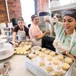 Production Manager Joelyn Vargas added frosting to cupcakes during the opening of Magnolia Bakery in Faneuil Hall.