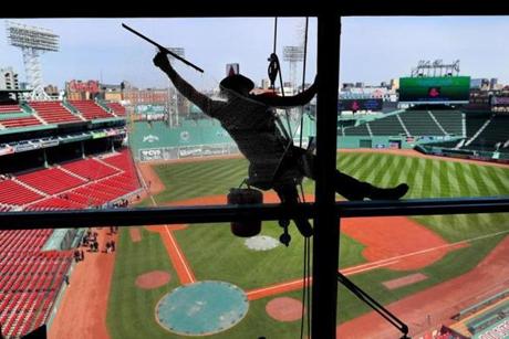 Workers prepared the American flag to be unfurled on the Green Monster Thursday. 
