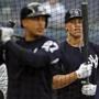 NEW YORK, NY - APRIL 6: Aaron Judge #99 of the New York Yankees watches Giancarlo Stanton #27 of the New York Yankees during batting practice prior to their game against the Baltimore Orioles at Yankee Stadium on April 6, 2018 in the Bronx borough of New York City. (Photo by Adam Hunger/Getty Images)