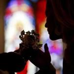 A woman kissed a reliquary of St. John Paul II after Cardinal Sean O?Malley dedicated St. John Paul II Divine Mercy Shrine in Salem on Sunday. 