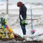 A woman pays her respects at a makeshift memorial to the victims of last week?s fatal bus crash near Tisdale, Saskatchewan.