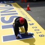 Jonathan Rodriguez of Peabody worked to lay down the Finish Line for the 2018 Boston Marathon on Boylston Street on Thursday.