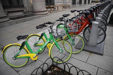 Two dockless LimeBike bicycles shared the sidewalk with other docked bikes in Washington, D.C. 
