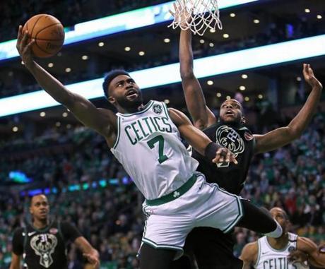 Boston, MA: 4/15/18: The Celtic Jaylen Brown drives to the basket against the Bucks Khris Middleton. The Boston Celtics hosted the Milwaukee Bucks in Game One of an Eastern Conference First Round NBA Playoff basketball game at the TD Garden. (Jim Davis/Globe Staff)
