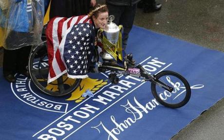 MARATHON SLIDER Boston, MA--4/16/2018-- Women's wheelchair race winner Tatyana Mcfadden receives her trophy at the finish line of the 122nd Boston Marathon. (Jessica Rinaldi/Globe Staff) Topic: Reporter:
