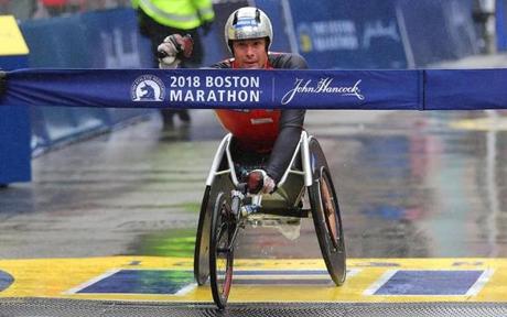 MARATHON SLIDER Boston04/16/18 The Boston Marathon finish line. Mens wheelchair winner Marcel Hug cross finish line. Photo by John Tlumacki/Globe Staff(sports)
