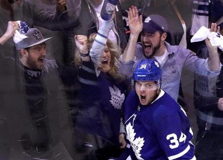 Toronto, Ontario - 4/16/2018 - (2nd period) Toronto Maple Leafs center Auston Matthews (34) scored his first goal of the playoffs for the 3-2 lead over the Boston Bruins which was appreciated by actress and Maple Leafs fan Elizabeth Moss, second from left, of Mad Men and The handmaiden's Tale fame. The Toronto Maple Leafs host the Boston Bruins in Game 3 at the Air Canada Centre in Toronto. - (Barry Chin/Globe Staff), Section: Sports, Reporter: Kevin P. Dupont , Topic: 17Maple Leafs-Bruins, LOID: 8.4.1612772118.
