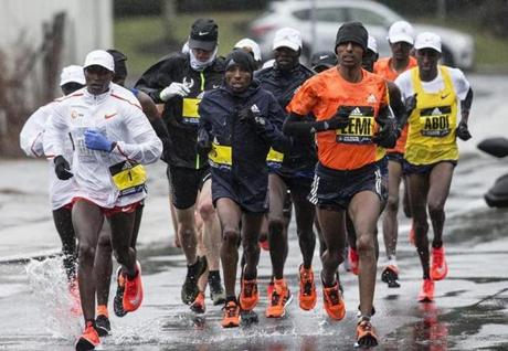 Natick, MA - 4/16/2018 - elite men's runners run through the rain along the route of the Boston Marathon in Natick, MA, Apr. 16, 2018. (Keith Bedford/Globe Staff) 
