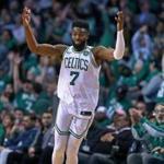 Boston, MA: 4/17/18: The Celtics Jaylen Brown calls for the crowd to get out of their seats in celebration after he hit a shot that put Boston ahead 118-99, on their way to a 120-106 victory. The Boston Celtics hosted the Milwaukee Bucks in Game Two of an Eastern Conference First Round NBA Playoff basketball game at the TD Garden. (Jim Davis/Globe Staff)