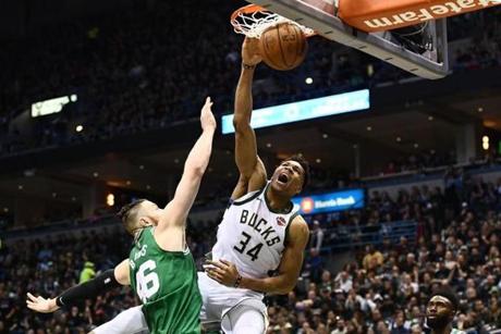 MILWAUKEE, WI - APRIL 20: Giannis Antetokounmpo #34 of the Milwaukee Bucks dunks over Aron Baynes #46 of the Boston Celtics during the second half of game three of round one of the Eastern Conference playoffs at the Bradley Center on April 20, 2018 in Milwaukee, Wisconsin. NOTE TO USER: User expressly acknowledges and agrees that, by downloading and or using this photograph, User is consenting to the terms and conditions of the Getty Images License Agreement. (Photo by Stacy Revere/Getty Images)
