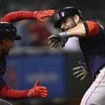 Boston Red Sox's Mitch Moreland, right, celebrates with Mookie Betts after hitting a grand slam off Oakland Athletics' Emilio Pagan during the sixth inning of a baseball game Friday, April 20, 2018, in Oakland, Calif. (AP Photo/Ben Margot)