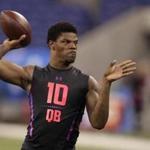 Louisville quarterback Lamar Jackson runs a drill at the NFL football scouting combine in Indianapolis, Saturday, March 3, 2018. (AP Photo/Michael Conroy)