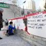 People sign a memorial after a driver plowed a rented van along a crowded sidewalk, killing multiple people and injuring others, Monday, April 23, 2018, in Toronto. (Nathan Denette/The Canadian Press via AP)