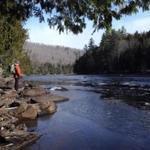 Russell Walters paused by the Kennebec River. A proposed hydropower line would cross over the Kennebec River Gorge. 