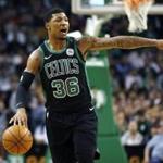 Boston Celtics' Marcus Smart signals during the first quarter of an NBA basketball game against the Indiana Pacers in Boston, Sunday, March 11, 2018. (AP Photo/Michael Dwyer)