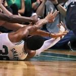 Boston, MA: 4-24-18: The Celticsw Marcus Smart, after winning a loose ball battle makes a nice pass from the floor to teammate Al Horford, who took the ball and scored on a drive to give Boston a 86-79 lead. The Boston Celtics hosted the Milwaukee Bucks for Game Five of their NBA Eastern Conference first round playoff series at the TD Garden. (Jim Davis/Globe Staff)