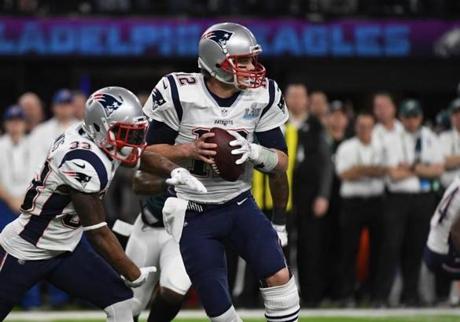 (FILES) In this file photo taken on February 04, 2018 Tom Brady (12) of the Patriots prepares to pass during Super Bowl LII between the New England Patriots and the Philadelphia Eagles at US Bank Stadium in Minneapolis, Minnesota, on February 4, 2018. New England Patriots quarterback Tom Brady is among the NFL players who will have to look for a new helmet after next season after 10 headgear models were banned April 16, 2018. In a move to combat concussions after concerns for years that not enough was being done to protect players, the league and the NFL Players Association released laboratory performance test results on helmet brands.They announced 10 models would be prohibited, although players who used four of them in the 2017 season could have one final campaign with them in 2018. / AFP PHOTO / TIMOTHY A. CLARYTIMOTHY A. CLARY/AFP/Getty Images
