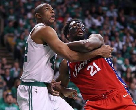 Boston, MA: 4-28-18: The Celtics Al Horford (left) and the 76ers Joel Embiid battle for position under the boards in the second half. The Boston Celtics hosted the Philadelphia 76ers for Game One of their NBA Eastern Conference Semi-Finals playoff series at the TD Garden. (Jim Davis/Globe Staff)
