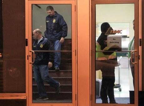 In this 2012 photo, federal agents are seen in NECC offices in Framingham.
