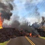 PAHOA, HI - MAY 5: In this handout photo provided by the U.S. Geological Survey, lava from a fissure slowly advances to the northeast on Hookapu Street after the eruption of Hawaii's Kilauea volcano on May 5, 2018 in the Leilani Estates subdivision near Pahoa, Hawaii. The governor of Hawaii has declared a local state of emergency near the Mount Kilauea volcano after it erupted following a 5.0-magnitude earthquake, forcing the evacuation of nearly 1,700 residents. (Photo by U.S. Geological Survey via Getty Images)