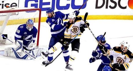 Tampa, Florida - 5/06/2018 - (3rd period) Tampa Bay Lightning goaltender Andrei Vasilevskiy (88) makes a save as both Bruins right wing David Pastrnak (88) and center Patrice Bergeron (37) are tied up during the third period. The Boston Bruins play the Tampa Bay Lightning in Game Five of the Eastern Conference second round of the Stanley Cup Playoffs at Amalie Arena in Tampa, FL. - (Barry Chin/Globe Staff), Section: Sports, Reporter: Kevin P. Dupont , Topic: 07Bruins-Lightning, LOID: 8.4.1824583991.
