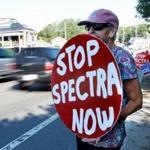 Weymouth, MA: 07-27-2016: Protestors opposing construction of a Spectra Energy natural gas compressor plant, including Dotty Anderson of Weymouth, line the roadway coming off the Fore River Bridge by the plant site in Weymouth, Mass. July 27, 2016. (Note: When photo was taken, there were seven protestors participating, but they were spread along the roadway and could not all be included in one photo.) Photo/John Blanding, Boston Globe staff story/Kathy McCabe, Metro ( 28weymouth )