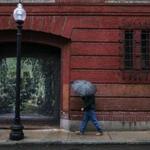 Boston, MA- April 25, 2018: A pedestrian protects himself from the rain on Salem Street in the North End neighborhood of Boston, MA on April 25, 2018. It?s starting slow, but the National Weather Service says the rain will intensify this afternoon and during the Wednesday evening commute, possibly creating hazardous conditions on the roadways. The rain arrived in Greater Boston around 6:30 a.m. and will increase in intensity. (Craig F. Walker/Globe Staff) section: metro reporter: