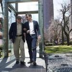 Steve Ross (left), founder of the New England Holocaust Memorial, walks through the memorial with his son, Mike.