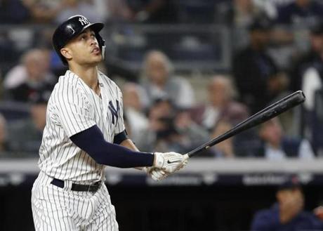 New York Yankees designated hitter Giancarlo Stanton watches his solo home run during the fourth inning of a baseball game against the Boston Red Sox in New York, Tuesday, May 8, 2018. (AP Photo/Kathy Willens)
